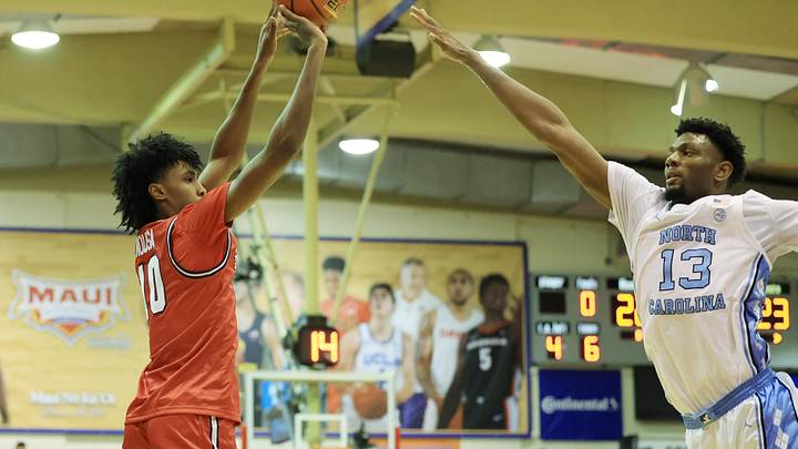 Nov 25, 2024; Lahaina, Hawaii, USA;  Dayton Flyers guard Hamad Mousa (10) attempts a three pointer over North Carolina Tar Heels forward Jalen Washington (13) during the first half of an NCAA college basketball game at Lahaina Civic Center. Mandatory Credit: Marco Garcia-Imagn Images