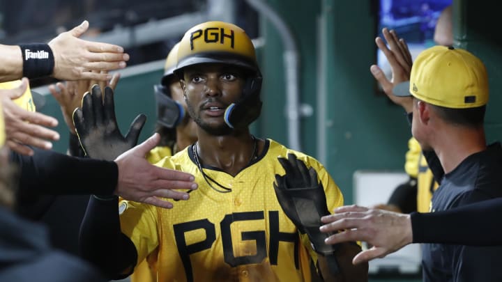 Aug 16, 2024; Pittsburgh, Pennsylvania, USA;  Pittsburgh Pirates center fielder Michael A. Taylor (18) high-fives in the dugout after scoring a run against the Seattle Mariners during the seventh inning at PNC Park. Mandatory Credit: Charles LeClaire-USA TODAY Sports