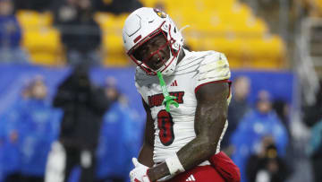 Oct 14, 2023; Pittsburgh, Pennsylvania, USA; Louisville Cardinals wide receiver Chris Bell (0) reacts after a seven yard touchdown catch against the Pittsburgh Panthers during the first quarter at Acrisure Stadium. 
