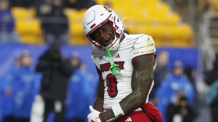 Oct 14, 2023; Pittsburgh, Pennsylvania, USA; Louisville Cardinals wide receiver Chris Bell (0) reacts after a seven yard touchdown catch against the Pittsburgh Panthers during the first quarter at Acrisure Stadium. 