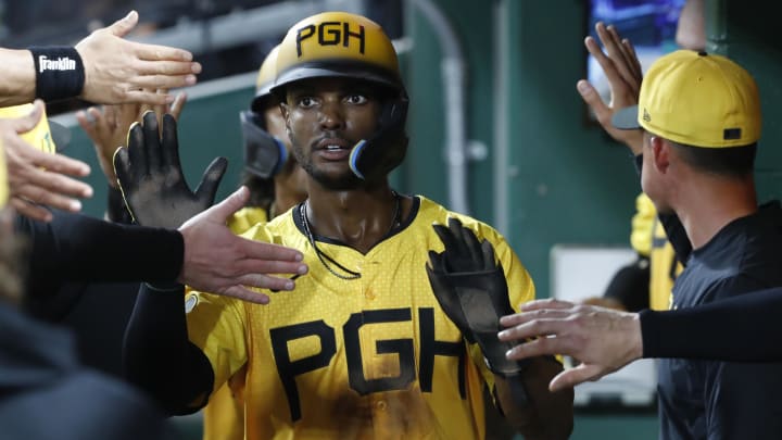 Pittsburgh Pirates center fielder Michael A. Taylor (18) high-fives in the dugout after scoring a run against the Seattle Mariners during the seventh inning at PNC Park. 