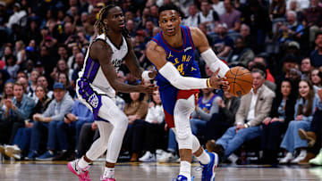 Mar 5, 2025; Denver, Colorado, USA; Denver Nuggets guard Russell Westbrook (4) controls the ball as Sacramento Kings guard Keon Ellis (23) guards in the fourth quarter at Ball Arena. Mandatory Credit: Isaiah J. Downing-Imagn Images