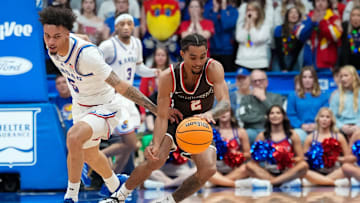 Dec 22, 2024; Lawrence, Kansas, USA; Kansas Jayhawks guard Zeke Mayo (5) and Brown Bears guard Jeremiah Jenkins (2) fight for a loose ball during the second half at Allen Fieldhouse. Mandatory Credit: Denny Medley-Imagn Images
