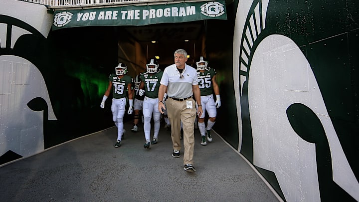 Aug 30, 2019; East Lansing, MI, USA; Michigan State Spartans head strength and conditioning coach Ken Mannie leads the Spartan defense out of the tunnel prior to a game against the Tulsa Golden Hurricane at Spartan Stadium. Mandatory Credit: Mike Carter-Imagn Images