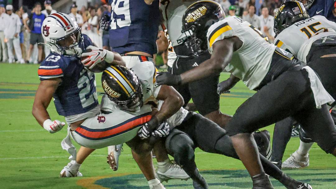 Southern Miss defenders make a tackle during Week 2's game at Auburn.