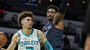 Oct 7, 2021; Charlotte, North Carolina, USA; Charlotte Hornets guard LaMelo Ball (2) dishes off covered by Memphis Grizzlies forward Jaren Jackson Jr. (13) during the second quarter at Spectrum Center. Mandatory Credit: Jim Dedmon-Imagn Images