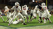 Nov 29, 2025; Charlottesville, Virginia, USA; Virginia Tech Hokies quarterback Kyron Drones (1) passes the ball from his own end zone against the Virginia Cavaliers in the third quarter at Scott Stadium. Mandatory Credit: Geoff Burke-Imagn Images