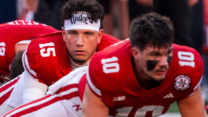 Sep 14, 2024; Lincoln, Nebraska, USA; Nebraska Cornhuskers quarterback Dylan Raiola (15) and quarterback Heinrich Haarberg (10) warm up before the game against the Northern Iowa Panthers at Memorial Stadium. 