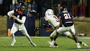Nov 29, 2025; Charlottesville, Virginia, USA; Virginia Cavaliers quarterback Chandler Morris (4) scrambles from Virginia Tech Hokies linebacker Kaleb Spencer (3) in the second quarter at Scott Stadium. Mandatory Credit: Geoff Burke-Imagn Images