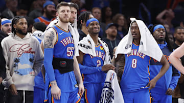 Feb 10, 2025; Oklahoma City, Oklahoma, USA; Oklahoma City Thunder guard Isaiah Joe (11), center Isaiah Hartenstein (55), forward Chet Holmgren (7), guard Shai Gilgeous-Alexander (2), forward Jalen Williams (8) and guard Luguentz Dort (5) watch the end of a game against the New Orleans Pelicans at Paycom Center. Mandatory Credit: Alonzo Adams-Imagn Images