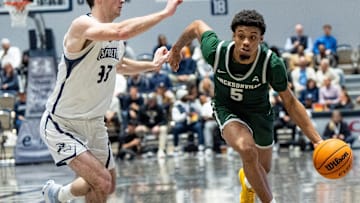 Jacksonville Dolphins guard Zach Bell (5) drives to the basket under North Florida Ospreys guard Oscar Berry (33) in the second half. Jacksonville University played University of North Florida Thursday night, February 20, 2025 in the River City Rumble in Jacksonville, Fl. UNF defeated JU 77-73. [Doug Engle/Florida Times-Union]2025