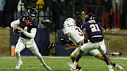 Nov 29, 2025; Charlottesville, Virginia, USA; Virginia Cavaliers quarterback Chandler Morris (4) scrambles from Virginia Tech Hokies linebacker Kaleb Spencer (3) in the second quarter at Scott Stadium. Mandatory Credit: Geoff Burke-Imagn Images