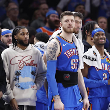Feb 10, 2025; Oklahoma City, Oklahoma, USA; Oklahoma City Thunder guard Isaiah Joe (11), center Isaiah Hartenstein (55), forward Chet Holmgren (7), guard Shai Gilgeous-Alexander (2), forward Jalen Williams (8) and guard Luguentz Dort (5) watch the end of a game against the New Orleans Pelicans at Paycom Center. Mandatory Credit: Alonzo Adams-Imagn Images