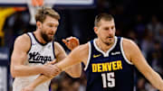 Denver Nuggets center Nikola Jokic (15) dribbles the ball up court as Sacramento Kings forward Domantas Sabonis (11) defends in the first quarter at Ball Arena.