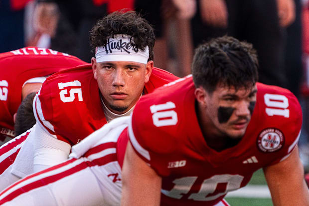 Nebraska Cornhuskers quarterback Dylan Raiola (15) and quarterback Heinrich Haarberg (10) warm up before the game.