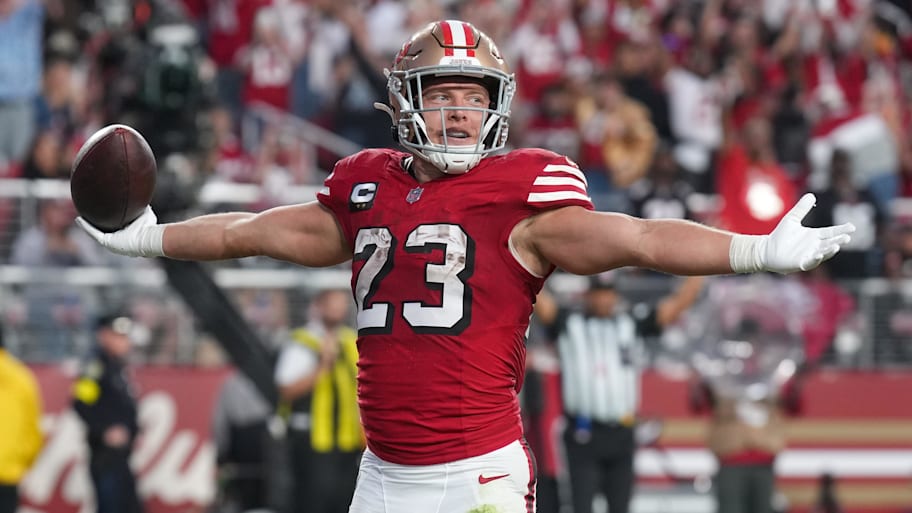 Christian McCaffrey holds his arms up after a touchdown.