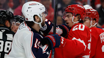 Blue Jackets center Adam Fantilli shoves Detroit Red Wings defenseman Albert Johansson.