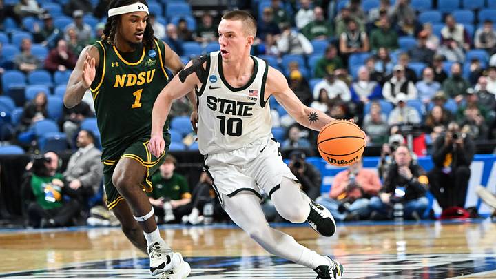 Mar 19, 2026; Buffalo, NY, USA; Michigan State Spartans guard Denham Wojcik (10) dribbles against North Dakota State Bison guard Damari Wheeler-Thomas (1) during the second half during a first round game of the men's 2026 NCAA Tournament at Keybank Center. Mandatory Credit: Mark Konezny-Imagn Images