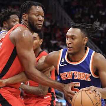 Dec 31, 2022; Houston, Texas, USA; New York Knicks guard Immanuel Quickley (5) dribbles against Houston Rockets forward Bruno Fernando (20) in the third quarter at Toyota Center. Mandatory Credit: Thomas Shea-Imagn Images