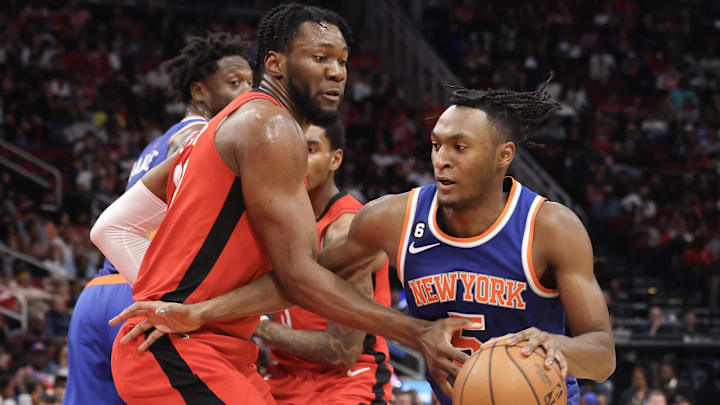 Dec 31, 2022; Houston, Texas, USA; New York Knicks guard Immanuel Quickley (5) dribbles against Houston Rockets forward Bruno Fernando (20) in the third quarter at Toyota Center. Mandatory Credit: Thomas Shea-Imagn Images