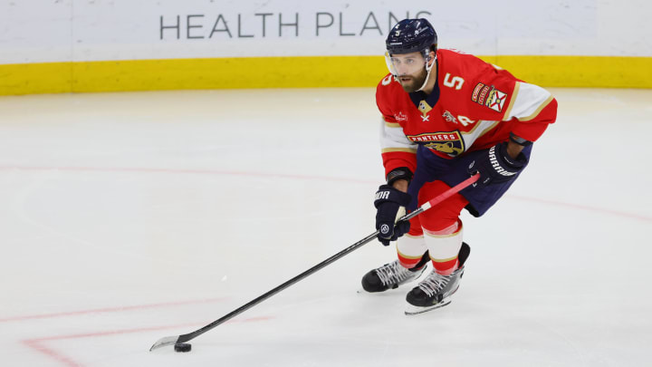 Mar 28, 2024; Sunrise, Florida, USA; Florida Panthers defenseman Aaron Ekblad (5) moves the puck against the New York Islanders during the first period at Amerant Bank Arena. Mandatory Credit: Sam Navarro-USA TODAY Sports