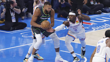 May 20, 2025; Oklahoma City, Oklahoma, USA; Minnesota Timberwolves center Rudy Gobert (27) and Oklahoma City Thunder guard Luguentz Dort (5) fight for a rebound during the first quarter in game one of the western conference finals for the 2025 NBA Playoffs at Paycom Center. Mandatory Credit: Alonzo Adams-Imagn Images