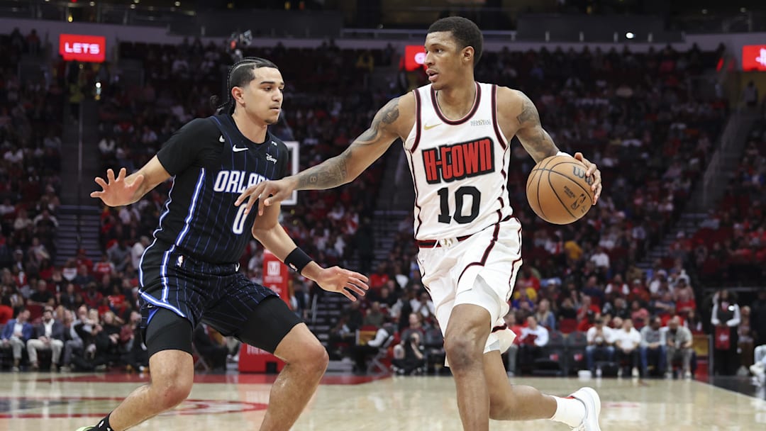 Mar 10, 2025; Houston, Texas, USA; Houston Rockets forward Jabari Smith Jr. (10) dribbles the ball as Orlando Magic guard Anthony Black (0) defends during the second quarter at Toyota Center. Mandatory Credit: Troy Taormina-Imagn Images