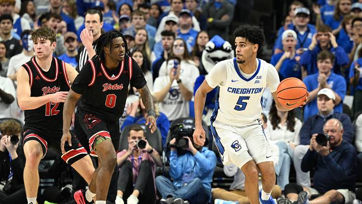 Nov 5, 2025; Omaha, Nebraska, USA;  Creighton Bluejays guard Nik Graves (5) dribbles against South Dakota Coyotes guard Jordan Crawford (0) during the first half at CHI Health Center Omaha. Mandatory Credit: Steven Branscombe-Imagn Images