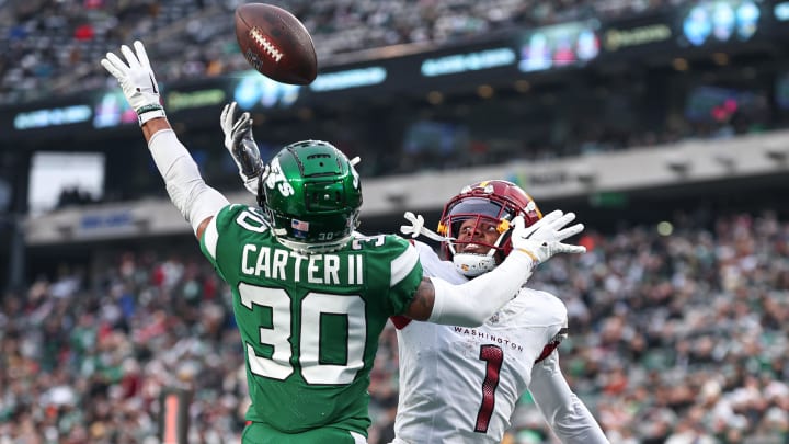 Dec 24, 2023; East Rutherford, New Jersey, USA; New York Jets cornerback Michael Carter II (30) breaks up a pass intended for Washington Commanders wide receiver Jahan Dotson (1) during the second half at MetLife Stadium.