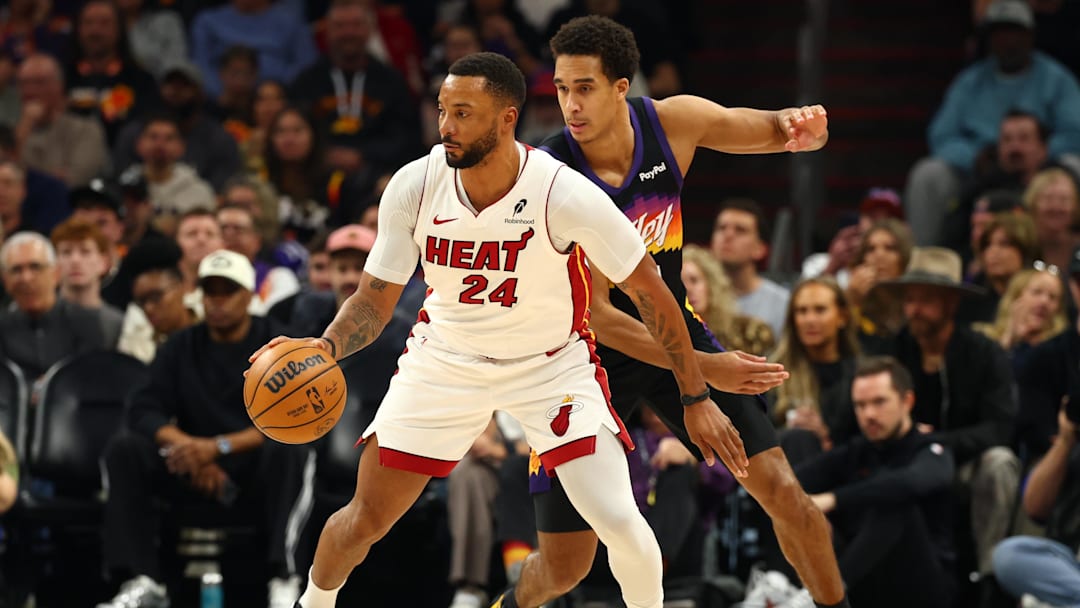 Jan 25, 2026; Phoenix, Arizona, USA; Miami Heat guard Norman Powell (24) against Phoenix Suns forward Oso Ighodaro (11) in the first half at Mortgage Matchup Center. Mandatory Credit: Mark J. Rebilas-Imagn Images