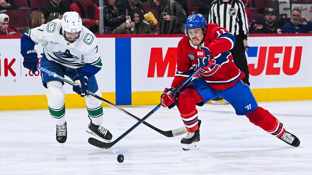 Jan 12, 2026; Montreal, Quebec, CAN; Montreal Canadiens right wing Brendan Gallagher (11) plays the puck against Vancouver Canucks defenseman Pierre-Olivier Joseph (7) during the second period at Bell Centre. Mandatory Credit: David Kirouac-Imagn Images