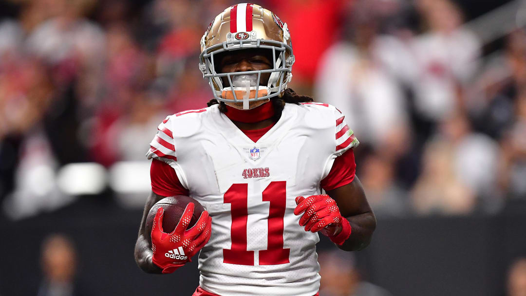 January 1, 2023; Paradise, Nevada, USA; San Francisco 49ers wide receiver Brandon Aiyuk (11) scores a touchdown against the Las Vegas Raiders during the first half at Allegiant Stadium. Mandatory Credit: Gary A. Vasquez-USA TODAY Sports