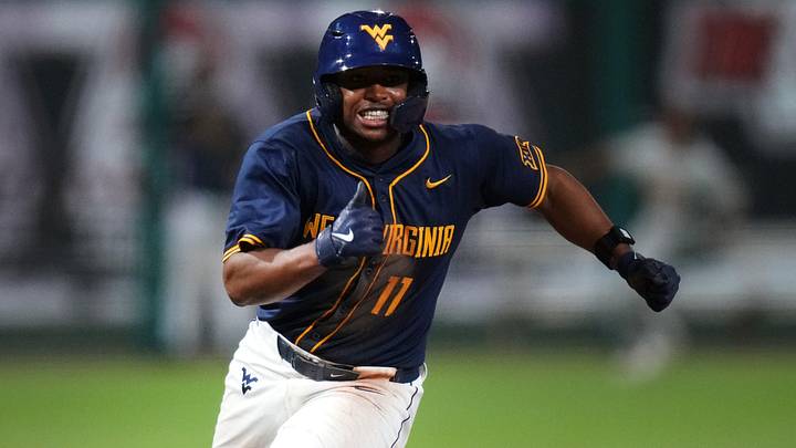 West Virginia Mountaineers base runner Sean Smith heads home to score a run against the ASU Sun Devils during their Big 12 tournament game at Surprise Stadium on May 22, 2026.