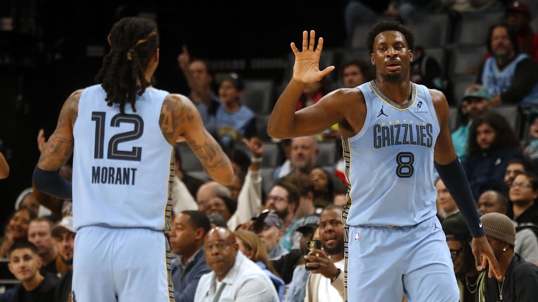 Jan 21, 2026; Memphis, Tennessee, USA; Memphis Grizzlies forward/center Jaren Jackson Jr. (8) reacts with guard Ja Morant (12) during the first quarter against the Atlanta Hawks at FedExForum. Mandatory Credit: Petre Thomas-Imagn Images
