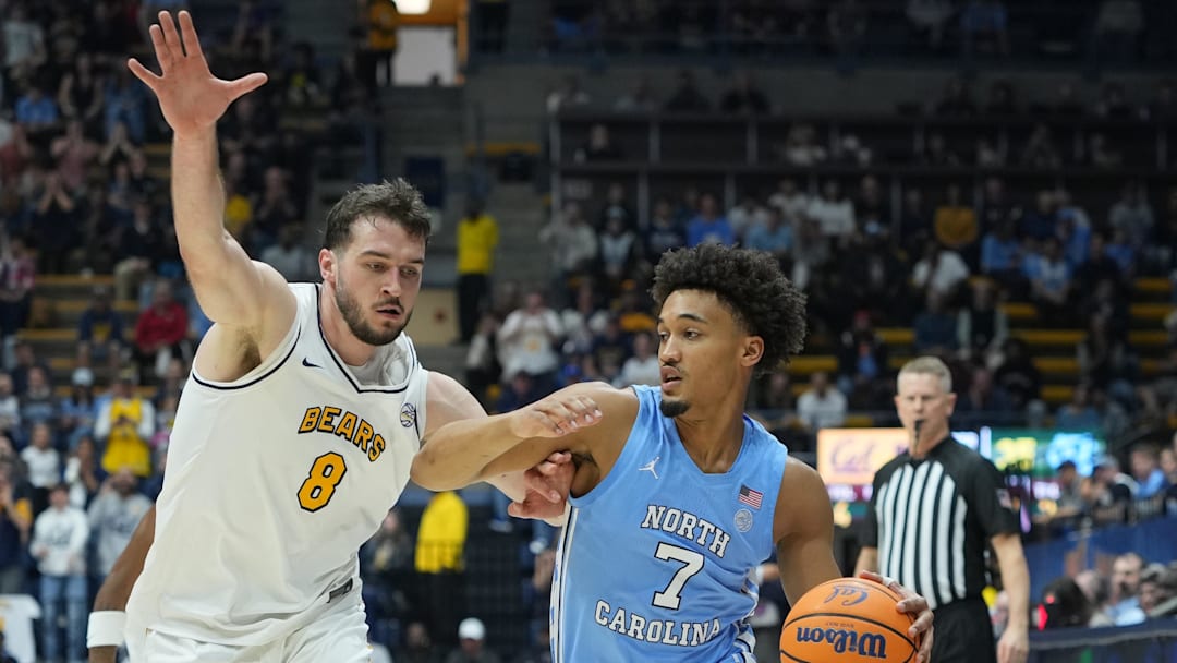 Jan 17, 2026; Berkeley, California, USA; North Carolina Tar Heels guard Seth Trimble (7) dribbles against California Golden Bears center Milos Ilic (8) during the first half at Haas Pavilion. Mandatory Credit: Darren Yamashita-Imagn Images