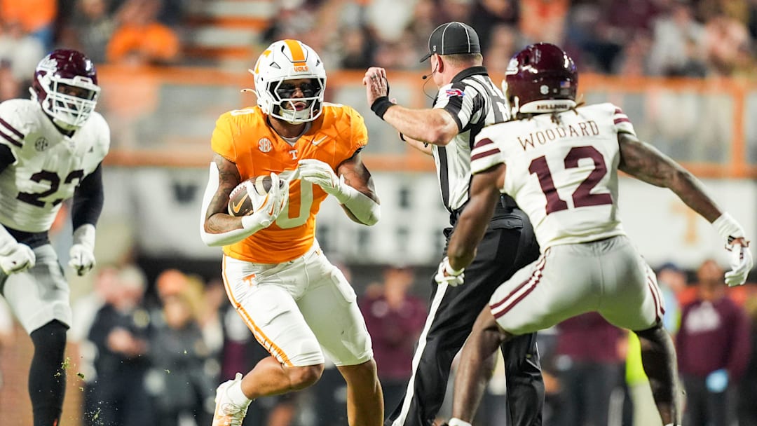 Tennessee tight end Ethan Davis (0) tries to move past a referee and Mississippi State safety Tyler Woodard (12) during a college football game between Tennessee and Mississippi State at Neyland Stadium in Knoxville, Tenn., on Saturday, Nov. 9, 2024.
