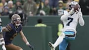 Nov 2, 2025; Green Bay, Wisconsin, USA; Carolina Panthers safety Tre'von Moehrig (7) intercepts a pass thrown by Green Bay Packers quarterback Jordan Love during the third quarter of their game at Lambeau Field. Mandatory Credit: Mark Hoffman-USA TODAY Network via Imagn Images