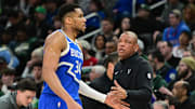 Milwaukee Bucks forward Giannis Antetokounmpo walks past  head coach Doc Rivers.