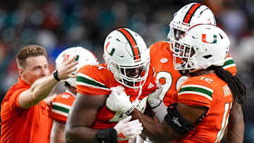 Oct 21, 2023; Miami Gardens, Florida, USA; Miami Hurricanes defensive lineman Rueben Bain Jr. (44) celebrates with teammates after sacking Clemson Tigers quarterback Cade Klubnik (2) (not pictured) during the second quarter at Hard Rock Stadium. Mandatory Credit: Rich Storry-Imagn Images