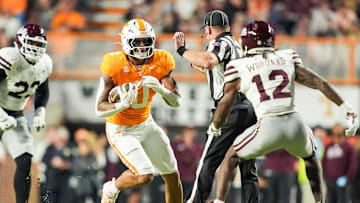 Tennessee tight end Ethan Davis (0) tries to move past a referee and Mississippi State safety Tyler Woodard (12) during a college football game between Tennessee and Mississippi State at Neyland Stadium in Knoxville, Tenn., on Saturday, Nov. 9, 2024.