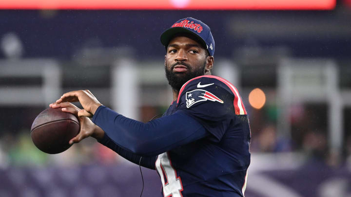 August 8, 2024; Foxborough, MA, USA;  New England Patriots quarterback Jacoby Brissett (14) tosses the ball on the sideline during the first half against the Carolina Panthers at Gillette Stadium. Mandatory Credit: Eric Canha-USA TODAY Sports