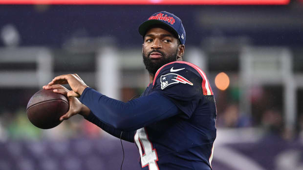 New England Patriots quarterback Jacoby Brissett (14) tosses the ball on the sideline during the first half against Panthers.