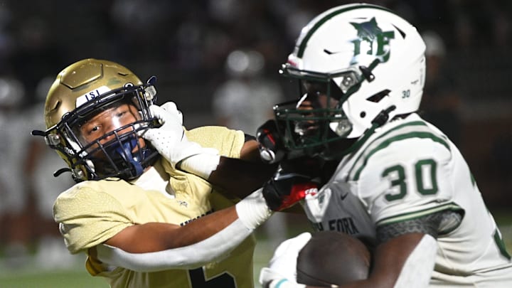 The Spartanburg Vikings played the Dutch Fork Silver Foxes in high school football at Spartanburg High School on Aug. 30, 2024. Spartanburg's Adrian Miller (6) fights Dutch Fork's Maurice Anderson (30) on a play. The Spartanburg Vikings played the Dutch Fork Silver Foxes in high school football at Spartanburg High School on Aug. 30, 2024. Spartanburg's Adrian Miller (6) fights Dutch Fork's Maurice Anderson (30) on a play.