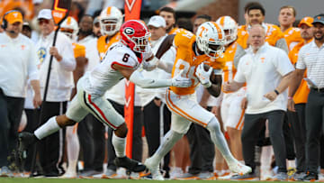 Nov 18, 2023; Knoxville, Tennessee, USA; Tennessee Volunteers wide receiver Kaleb Webb (84) runs the ball against Georgia Bulldogs defensive back Daylen Everette (6) during the first half at Neyland Stadium. Mandatory Credit: Randy Sartin-Imagn Images