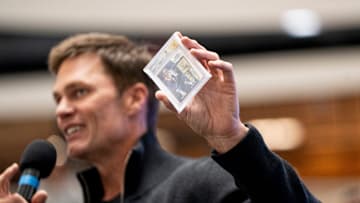 Tom Brady holds a card at American Dream for the grand opening of Card Vault by Tom Brady, a sports card and memorabilia retailer, East Rutherford, Friday, Apr. 11, 2025.