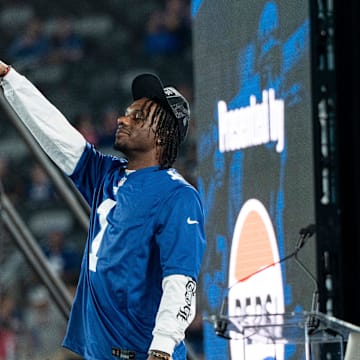 Malik Nabers raises his mic in the air during Giants Fan Fest at MetLife Stadium to celebrate 100 Seasons of the New York Giants, Friday, Sept. 6, 2024.