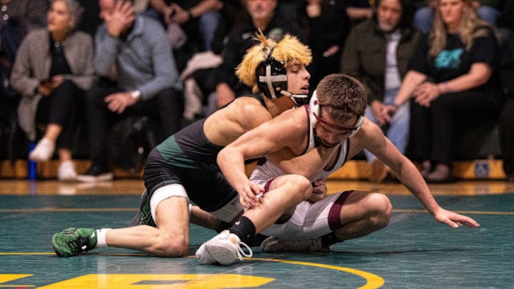 St. Joe Regional's JoJo Burke (left) wrestles Will Webb from Don Bosco in a recent 106 pound match.
