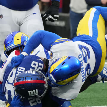 East Rutherford, NJ     December 31, 2023 -- Saquon Barkley of the Giants is tackled by Aaron Donald of the Rams in the second half. The Los Angeles Rams edged the New York Giants 26-25 on December 31, 2023 at MetLife Stadium in East Rutherford, NJ.