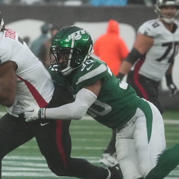 East Rutherford, NJ     December 3, 2023 -- Bijan Robinson of the Falcons is tackled by Michael Carter II of the Jets in the first half. The Atlanta Falcons topped the NY Jets 13-8 at MetLife Stadium on December 3, 2023 in East Rutherford, NJ.