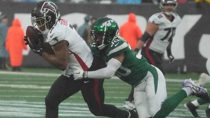 East Rutherford, NJ     December 3, 2023 -- Bijan Robinson of the Falcons is tackled by Michael Carter II of the Jets in the first half. The Atlanta Falcons topped the NY Jets 13-8 at MetLife Stadium on December 3, 2023 in East Rutherford, NJ.